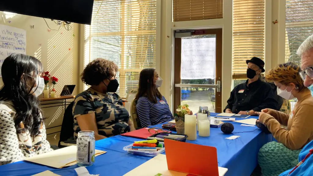 Students and seniors around table participating in Legacy Letters program